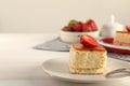 Piece of cheesecake with strawberry and fork on white table, closeup with space for text Royalty Free Stock Photo