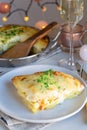 Piece of cheesy scalloped potatoes or potato gratin on a plate,