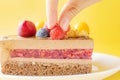 A piece of chocolate berry cake in a white plate on a yellow background. Royalty Free Stock Photo