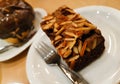 A piece of chocolate brownie cake toped with slided almonds Royalty Free Stock Photo