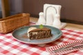 A piece of chocolate brownie pancake cake with vanilla ice-cream and chocolate sauce served on a blue plate. Royalty Free Stock Photo