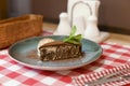 A piece of chocolate brownie pancake cake with vanilla ice-cream and chocolate sauce served on a blue plate. Royalty Free Stock Photo