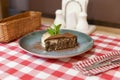 A piece of chocolate brownie pancake cake with vanilla ice-cream and chocolate sauce served on a blue plate. Royalty Free Stock Photo