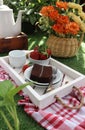 a piece of chocolate cake, a bowl of strawberries and a cup of tea