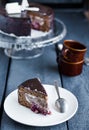 Piece of chocolate cake with cream and cherry on white plate Royalty Free Stock Photo