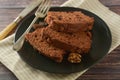 Piece of chocolate cake , fudge or pound cake. Wooden background