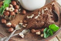 Piece of chocolate cake, mint leaves, hazelnuts and jar with milk Royalty Free Stock Photo