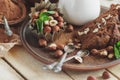 Piece of chocolate cake, mint leaves, hazelnuts and jar with milk Royalty Free Stock Photo