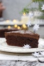 Piece of chocolate cake in white christmas table setting Royalty Free Stock Photo