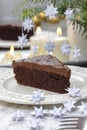 Piece of chocolate cake in white christmas table setting Royalty Free Stock Photo