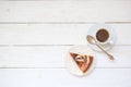 Piece of chokolate cake and cup of coffee on white wooden table. Top view image of restaurant or cafe menu background Royalty Free Stock Photo