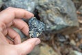 Piece of chromite ore in hand, selective focus
