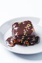 Piece of classic chocolate cake with colored sprinkles