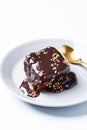 Piece of classic chocolate cake with colored sprinkles