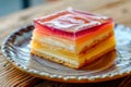 Piece of colorful jelly and custard Mille Feuille crepe cake on ceramic plate