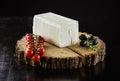 Piece of cream cheese, cherry tomatoes and olives on wooden boar