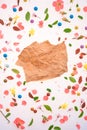 Piece of crumpled paper over colorful springtime background