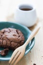 A piece of dark chocolate cookie with a cup ot hot tea Royalty Free Stock Photo