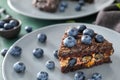 Piece of delicious blueberry chocolate cake on plate, closeup Royalty Free Stock Photo