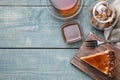 Piece of delicious cake with caramel served on wooden table, flat lay. Space for text Royalty Free Stock Photo