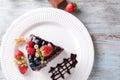 Piece of delicious chocolate cake with berries on plate Royalty Free Stock Photo