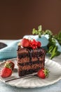 Piece of delicious chocolate cake with berries on plate Royalty Free Stock Photo