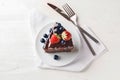 Piece of delicious chocolate cake with berries on plate Royalty Free Stock Photo