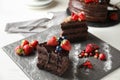 Piece of delicious chocolate cake with berries on slate plate Royalty Free Stock Photo