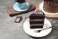 Piece of delicious chocolate cake with fresh berries on grey table Royalty Free Stock Photo