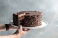 Piece of delicious chocolate cake on a plate. Layered chocolate cake Royalty Free Stock Photo