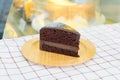 Piece of delicious chocolate cake on wooden plate Royalty Free Stock Photo