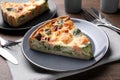 Piece of delicious homemade salmon quiche with broccoli and cutlery on wooden table, closeup Royalty Free Stock Photo