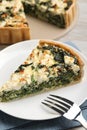 Piece of delicious homemade spinach quiche on plate, closeup Royalty Free Stock Photo