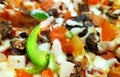 A piece of baked mouth-watering sumptuous pizzas cooked in the restaurant, the thin crust with bacon, beef, mushrooms, chicken, on