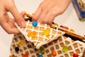 Piece of dissasembled homemade gingerbread house decorated with icing and sweets. Eating of gingerbread house after Christmas Royalty Free Stock Photo