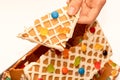 Piece of dissasembled homemade gingerbread house decorated with icing and sweets. Eating of gingerbread house after Christmas Royalty Free Stock Photo