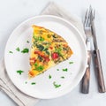 Piece of egg frittata with spinach, roasted peppers, mushrooms, cheese, top view, square format Royalty Free Stock Photo