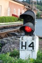 Piece of equipment shining a red light next to the train Royalty Free Stock Photo