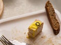 A piece of fish cake  lies on a plate with a slice of brown bread Royalty Free Stock Photo