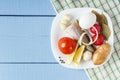 Piece of fish and fresh vegetables on wooden table with tablecloth. Top view on raw foodstuffs for dish cooking. Copy space Royalty Free Stock Photo