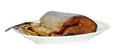 A piece of fish lies on a white plate on a white background in isolation Royalty Free Stock Photo