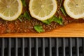 A piece of fish steak with lemons lies on a wooden board, baked, closeup Royalty Free Stock Photo