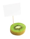 Piece of a fresh kiwi fruit with blank cardboard information tag