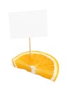 Piece of a fresh orange with blank cardboard information tag