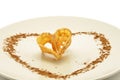 Piece of fried flower decorated with heart-shaped cinnamon Royalty Free Stock Photo