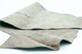 Piece of gray leather and suede cut on white background. Concept and idea of fine leather crafting, handmade, handcrafted