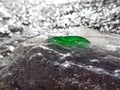 A piece of green glass in the oncoming wave Royalty Free Stock Photo