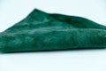 Piece of green leather and suede cut on white background. Concept and idea of fine leather crafting, handmade, handcrafted