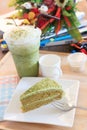 Piece of green tea cake and cool green tea ice in glass bottle a Royalty Free Stock Photo