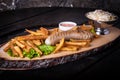 Piece of grilled sausage with french fries, ketchup and a plate of cabbage salad Royalty Free Stock Photo